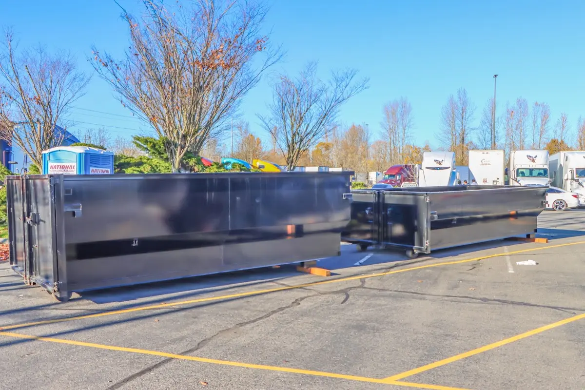 Professional dumpster rental service with roll-off container on residential driveway in Westchase